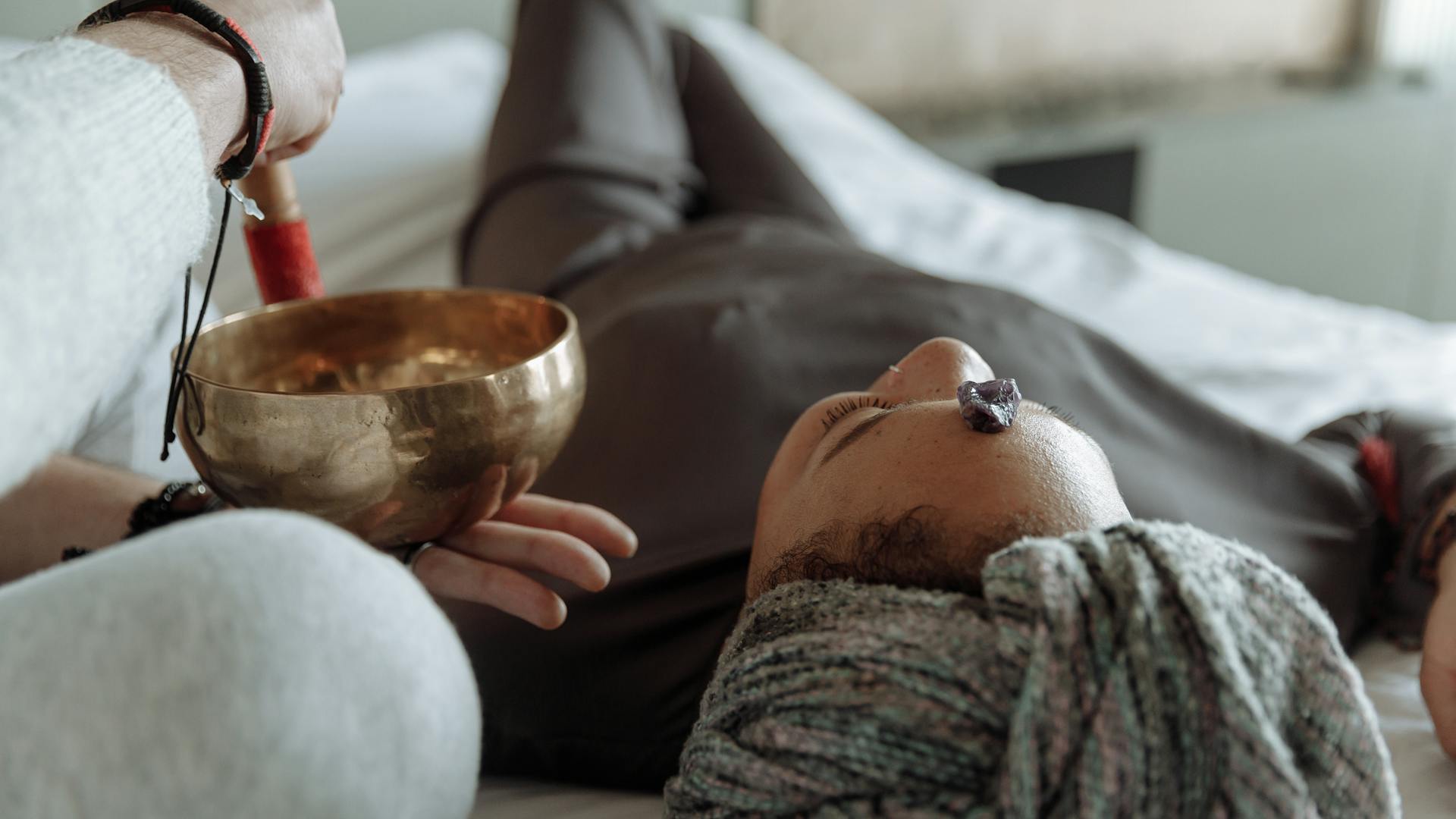 Sound healing session with singing bowls in a peaceful setting
